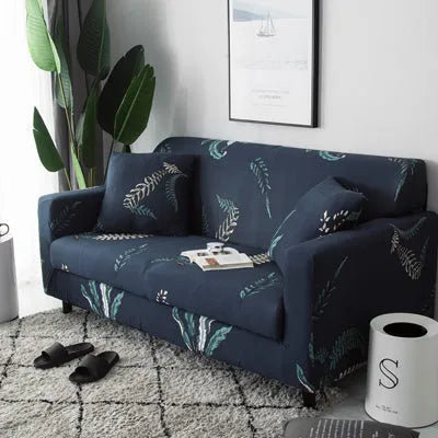 Printed stretchable sofa slipcover with geometric abstraction pattern on a three-seater sofa, showing tight fit and modern design.