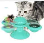 Cat playing with rotating windmill toy featuring luminous balls and suction base