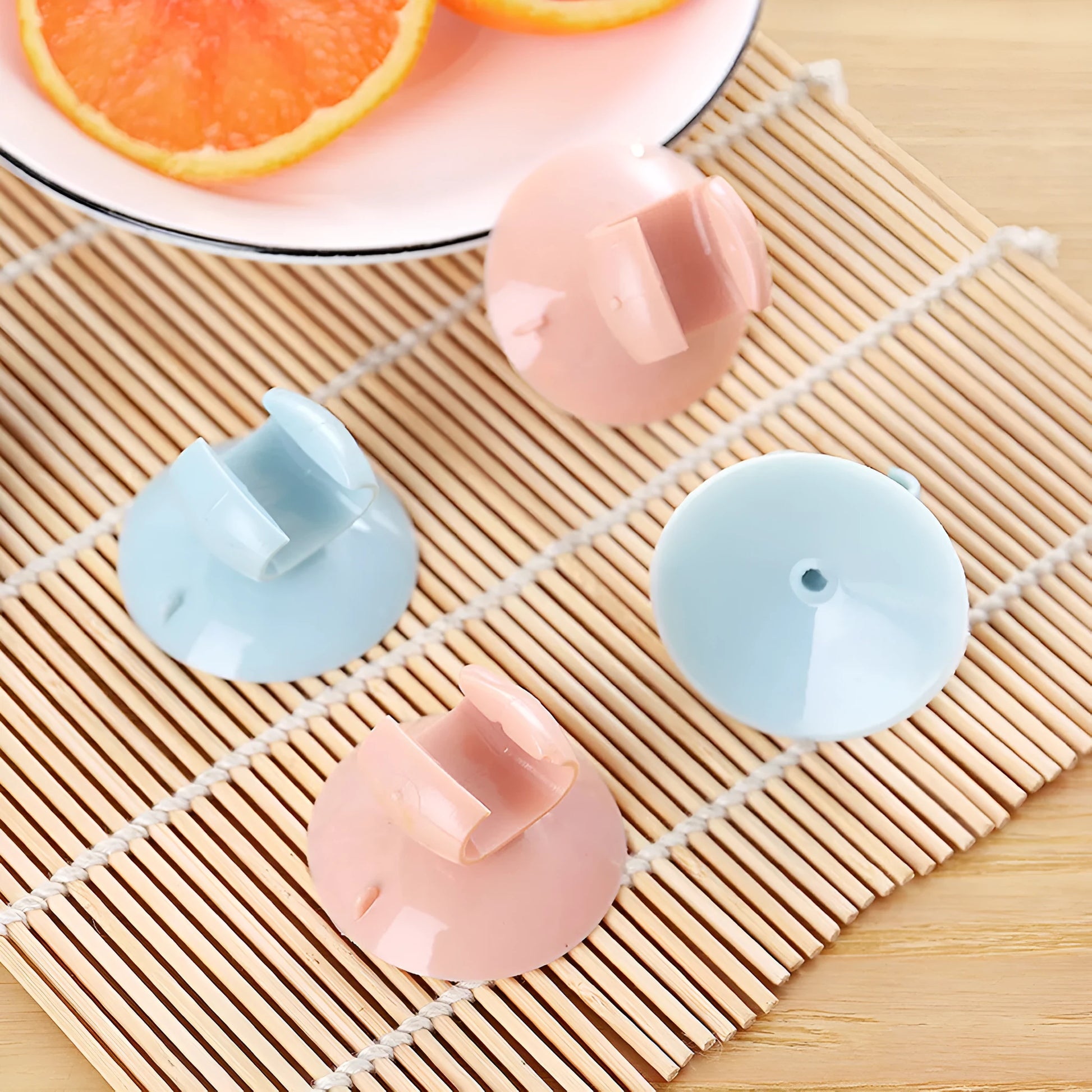 Blue PVC utensil holder with suction cup mounting a rice spoon on kitchen tiles