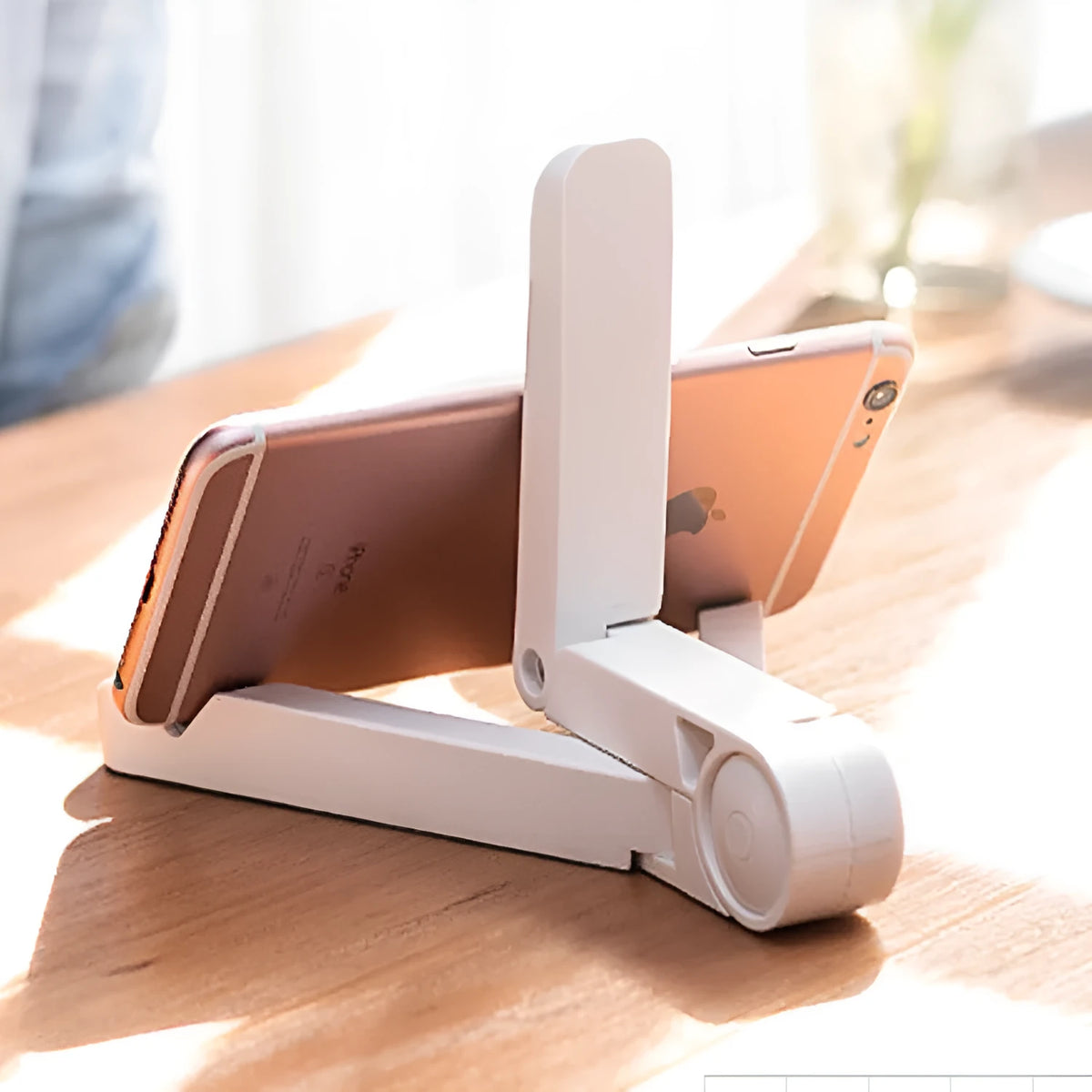 Black foldable tablet holder open in landscape mode holding a tablet, showing side buttons and non-slip base.