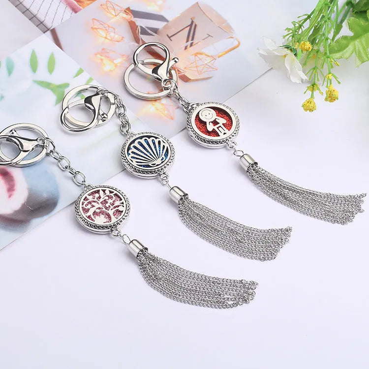 Alloy car aromatherapy pendant with tassel on 50cm chain beside coloured cotton pads for fragrance diffusion