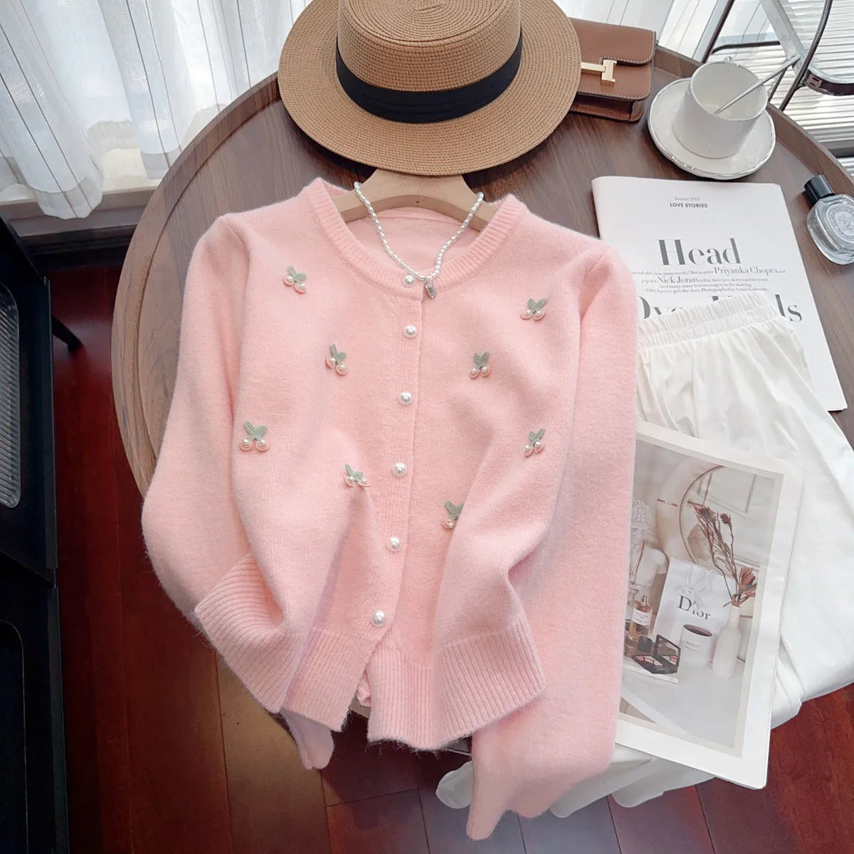 Pink women's slim fit cashmere cardigan coat with beaded details on a round neck.