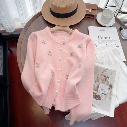 Pink women's slim fit cashmere cardigan coat with beaded details on a round neck.