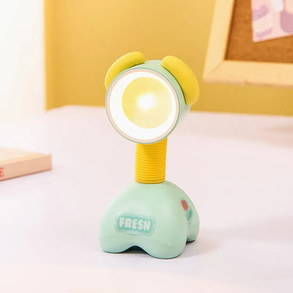Colourful cartoon character magnetic DIY night light on a desk with adjustable head.