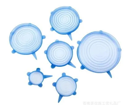 Set of six flexible silicone pot lids in assorted sizes on a kitchen counter.
