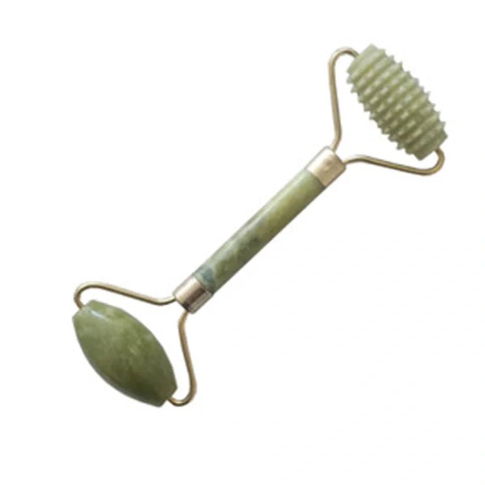 Natural green jade beauty massager with roller and scraper tools on white background