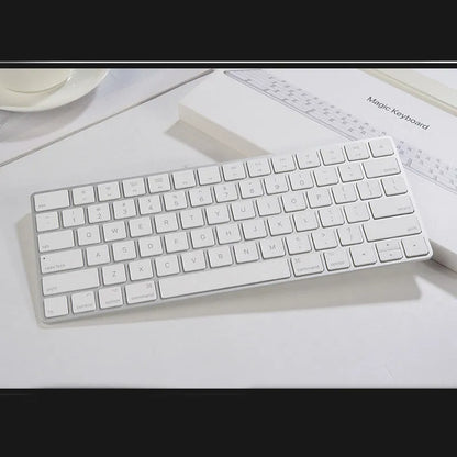 White Apple G6 ultra-thin metal Bluetooth wireless keyboard on a desk.