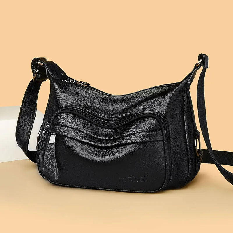 Large blue women's shoulder bag with crossbody strap and multiple internal compartments
