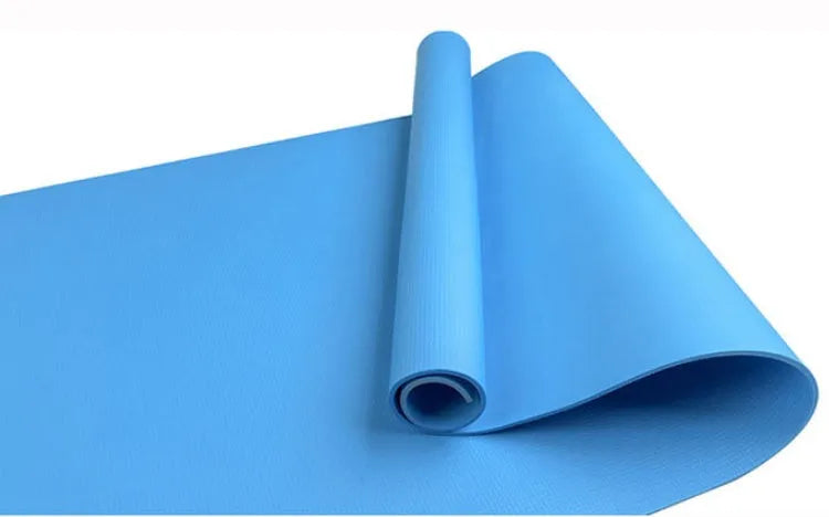 EVA composite fitness and yoga mat in blue, showing its texture and rolled edge next to a storage bag.