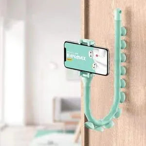 Flexible black rubber phone holder with suction cup mounted on a desk, holding a mobile phone at eye level.