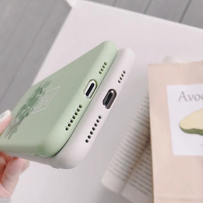 White silicone iPhone case with a painted green leaf plant design on the back.