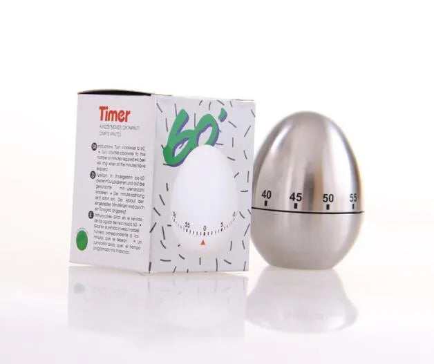 Stainless steel egg-shaped mechanical kitchen timer on a countertop.
