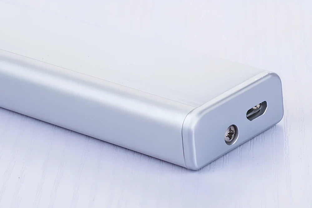 Wireless LED wardrobe light in 300mm size with motion sensor and charging pad, warm white glow, mounted on shelf