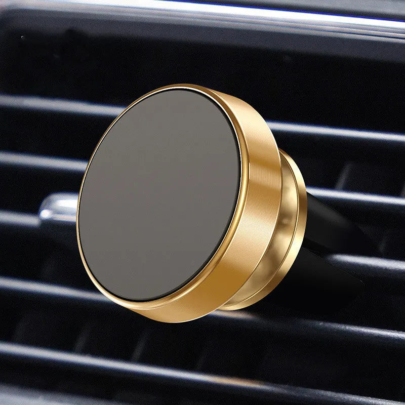 Silver aluminium alloy magnetic car phone holder with rotating ball head mounted on a car air vent.