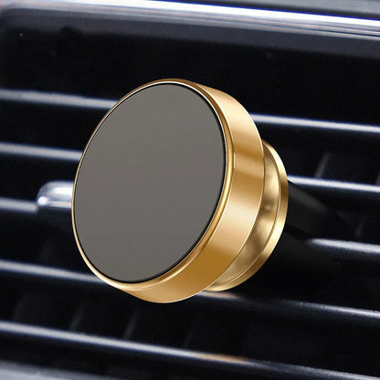 Silver aluminium alloy magnetic car phone holder with rotating ball head mounted on a car air vent.