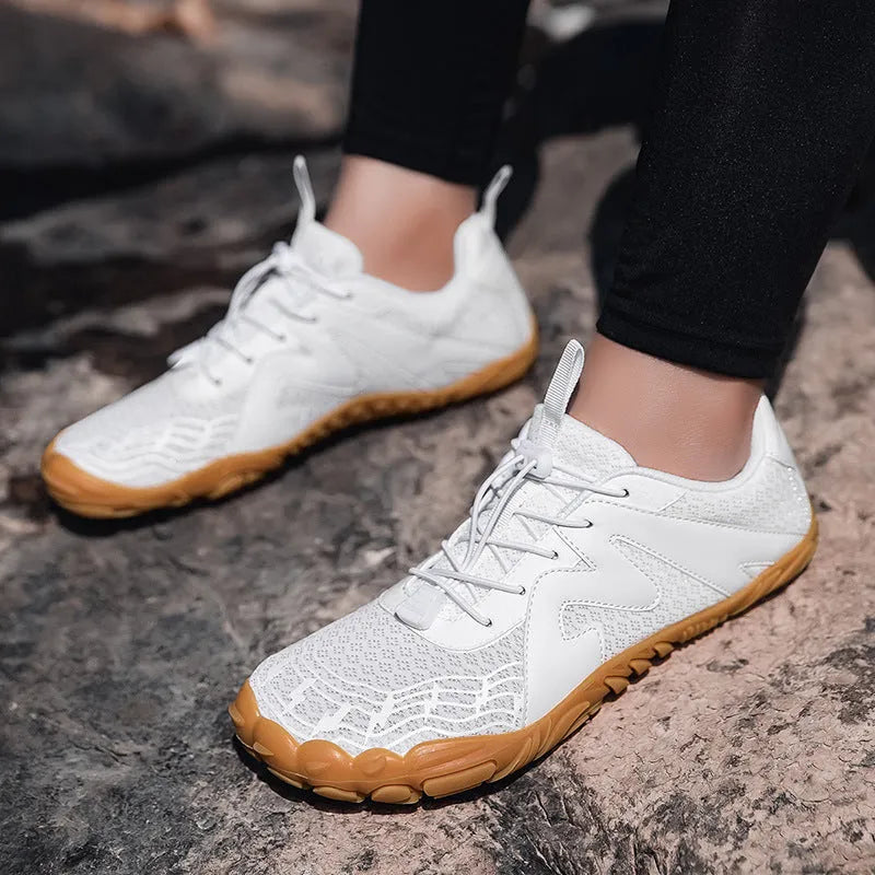 Climbing shoes with Flyknit lining and a rubber sole in A83 colour options on a climbing hold.