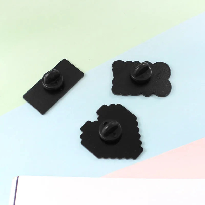 Stereo game console badge made from alloy metal, designed for bag or clothing attachment with independent OPP packaging, available in three colour options CC1122, CC1123, and CC1124, a collectible accessory for gaming enthusiasts.