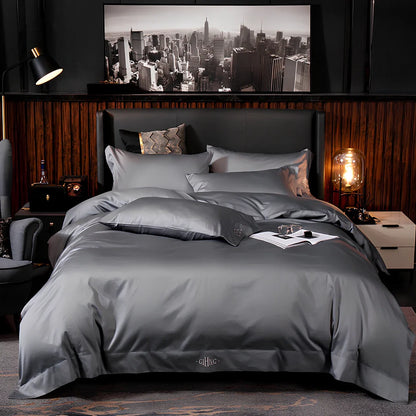 Four-piece cotton bedding set with satin weave fabric showing quilting detail and colour options