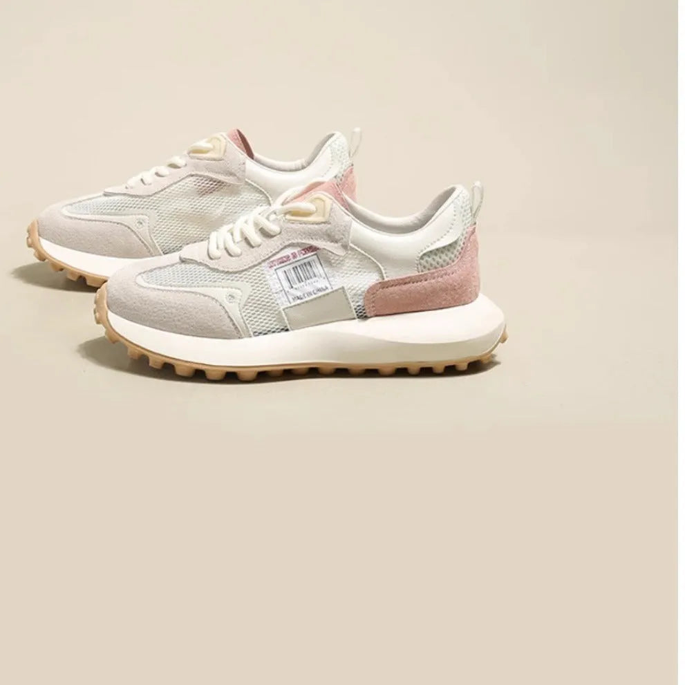 Women's grey low-top retro sneakers with mesh lining and round toe on a flat rubber sole.