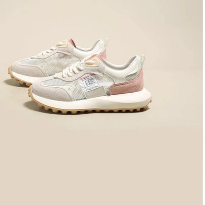 Women's grey low-top retro sneakers with mesh lining and round toe on a flat rubber sole.