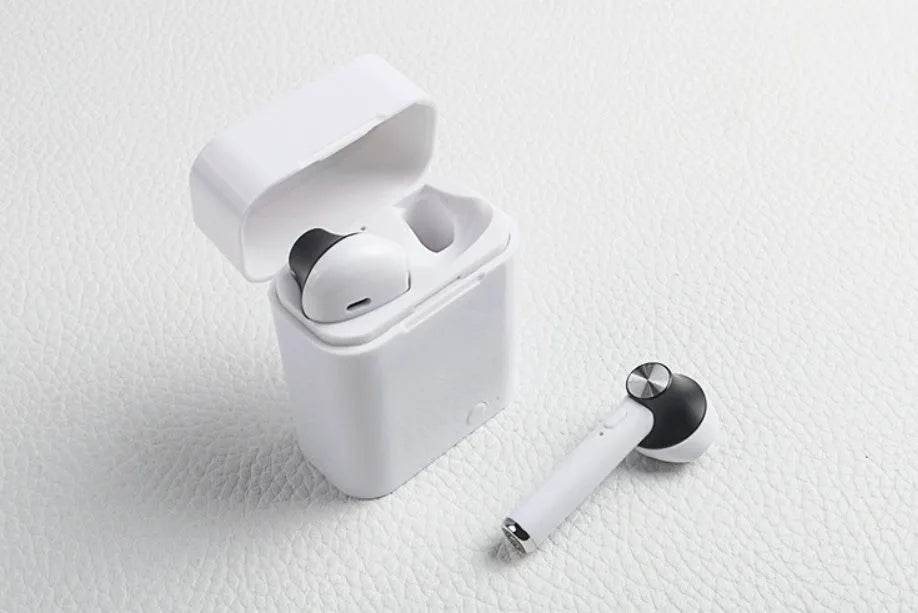 Black wireless sports Bluetooth earbuds showing battery display and placed next to a smartphone.