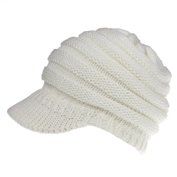Women's acrylic knitted ponytail beanie in a solid colour, shown on a model with a ponytail.