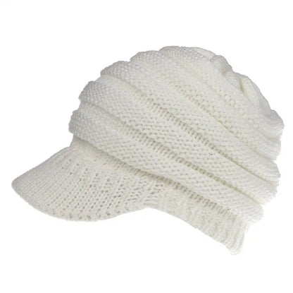 Women's acrylic knitted ponytail beanie in a solid colour, shown on a model with a ponytail.
