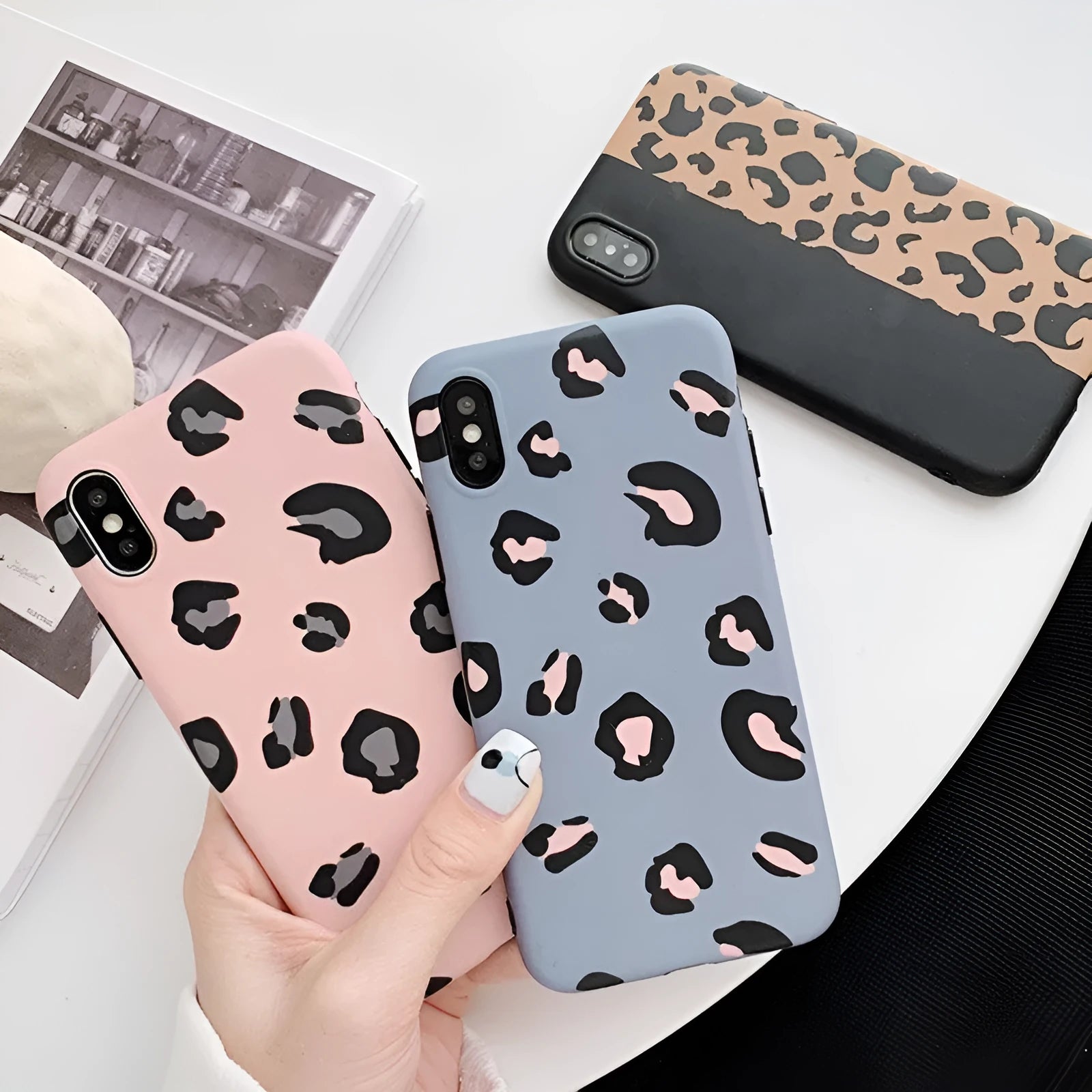 Leopard print protective phone case for iPhone, shown in black, blue, and pink colour options.