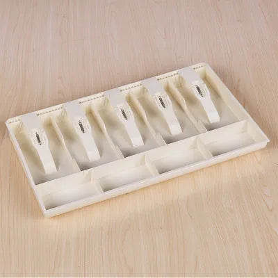 Black and white five-drawer ABS plastic cash register box for organising banknotes and coins.