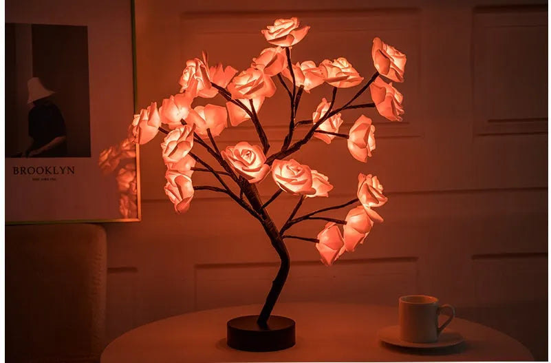 White and red rose flower LED lamp on a table with bonsai tree shape and warm white glow.