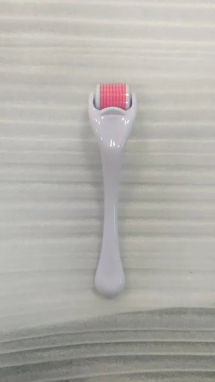Sterile micro needle derma roller with black handle and coloured wheel on white background