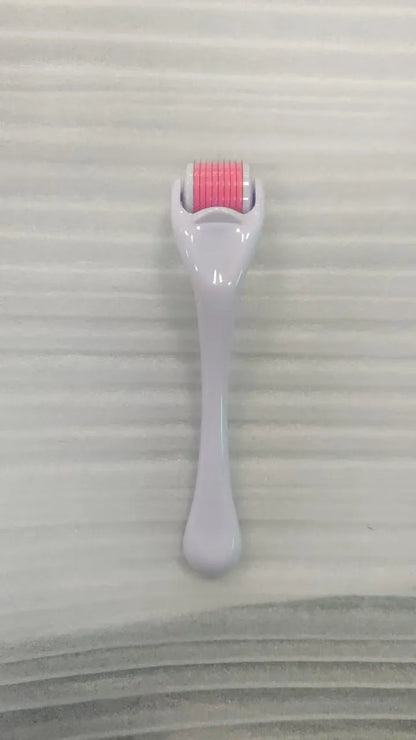Sterile micro needle derma roller with black handle and coloured wheel on white background