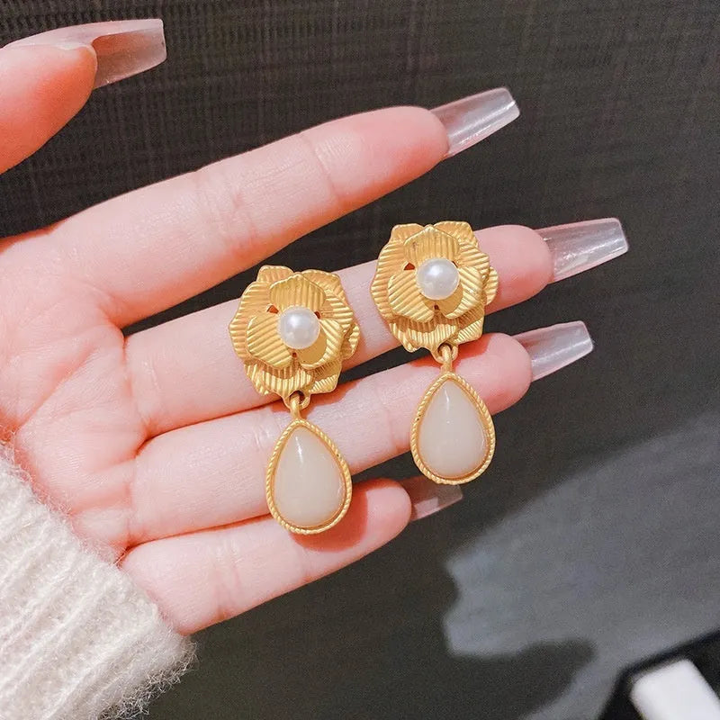 Gold-coloured floral stud earrings with a needle rose design, opal stone, and ice flower details.