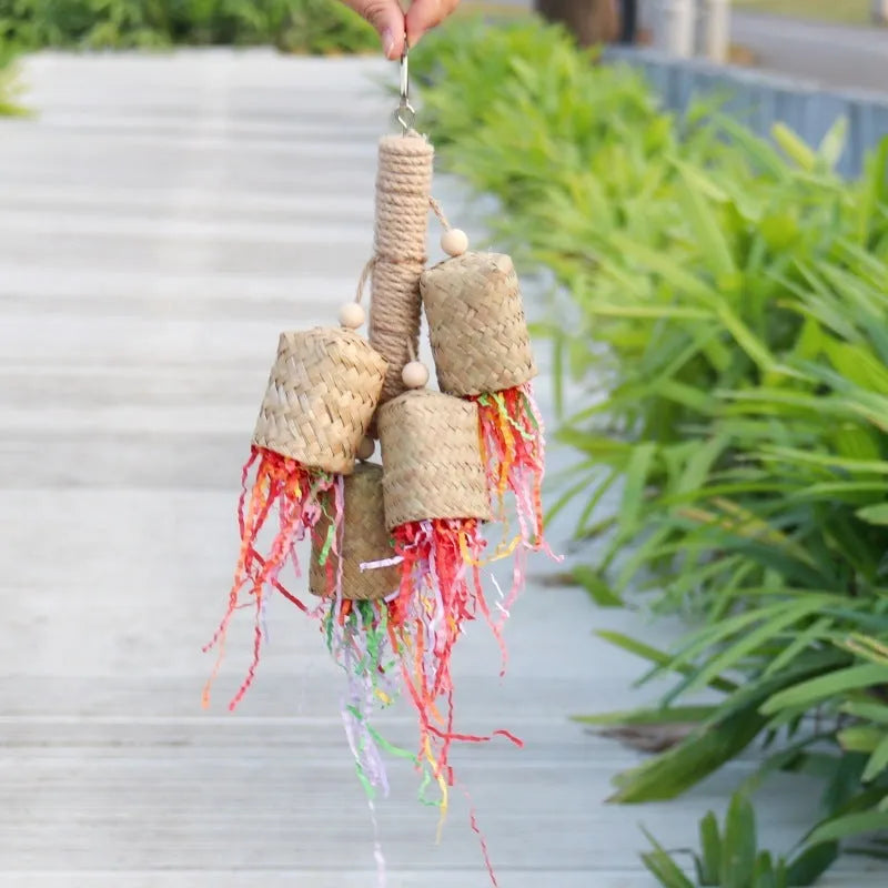 Natural wood and sisal rope shredded paper parrot activity toy measuring 15 by 35 centimetres.