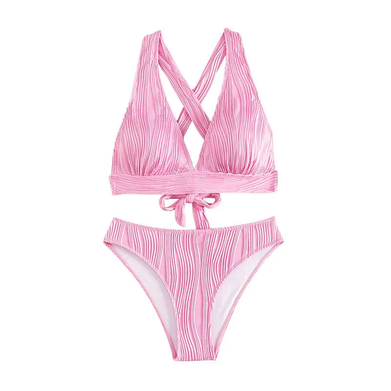 Pink and black women's halter strap bikini with split shorts on a white background