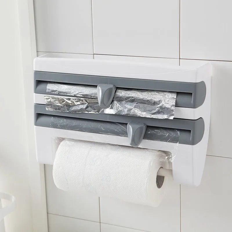 White wall-mounted kitchen roll holder dispenser for cling film, foil, and paper towels.