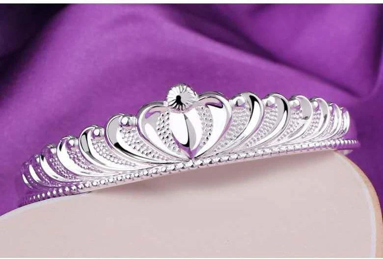 A close-up view of the elegant Crown Bracelet, showcasing its intricate crown-shaped design and shiny, rhodium-plated finish.