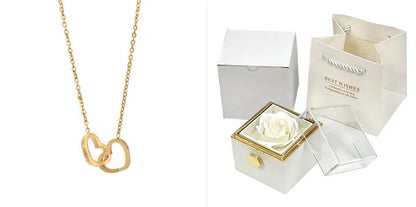 Rotating rose jewellery gift box with a preserved red rose under a clear acrylic dome, showing the interior rotating drawer.