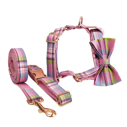 Four-piece dog accessory set showing cloth collar, leash, vest, and bow in coordinated colours