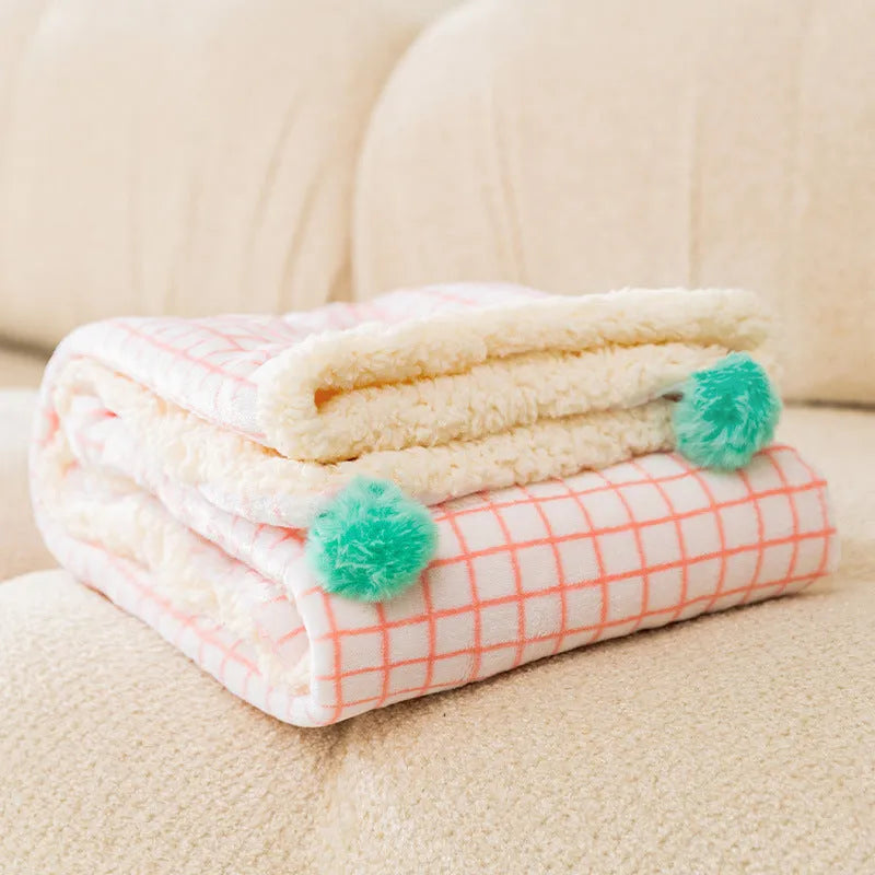 A blue coral fleece pet blanket laid flat, showing its soft texture and rectangular shape as a dog or cat bed mat.