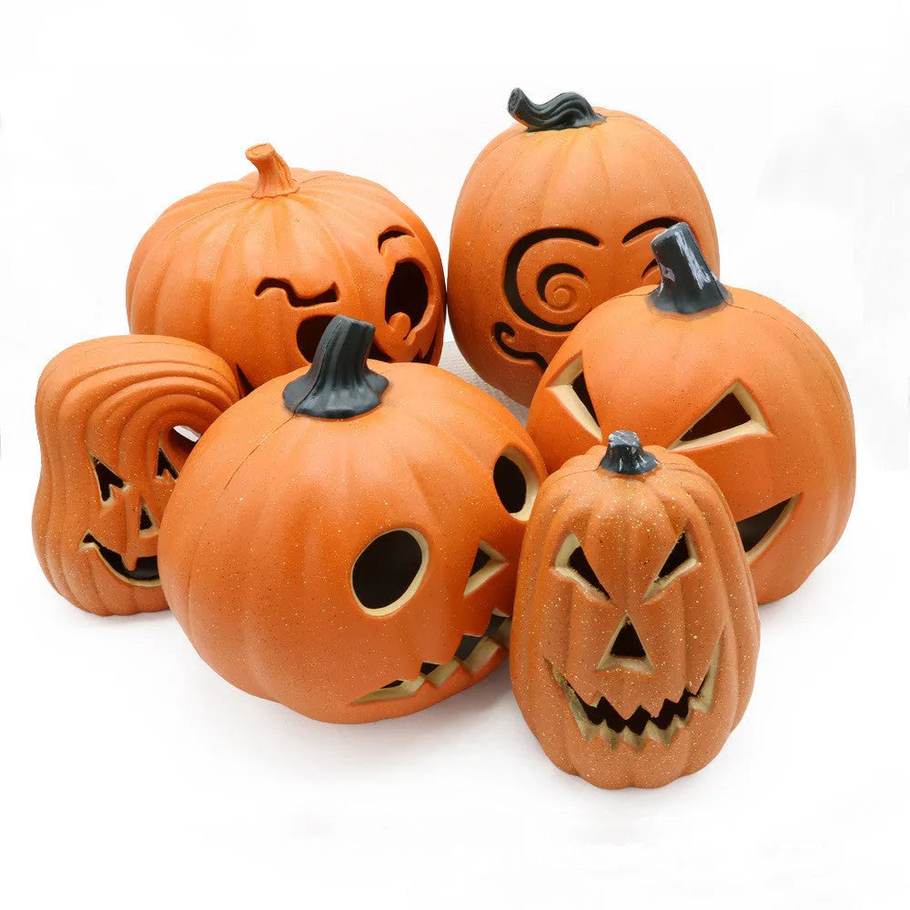 Yellow Halloween pumpkin lantern with hollow-out skull hooded design, resin prop measuring 23 x 19cm