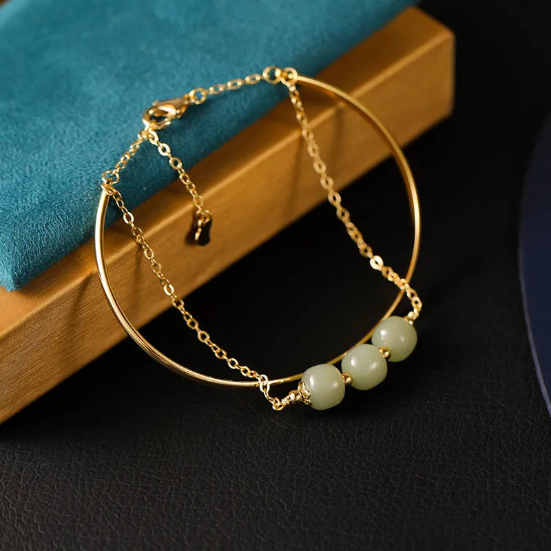 Women's Hetian jade lucky beads bracelet with gold inlay, shown in faux two-piece design.