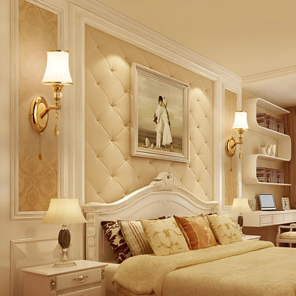European style wall lamp with glass shade mounted on a wall, showing the cable switch.