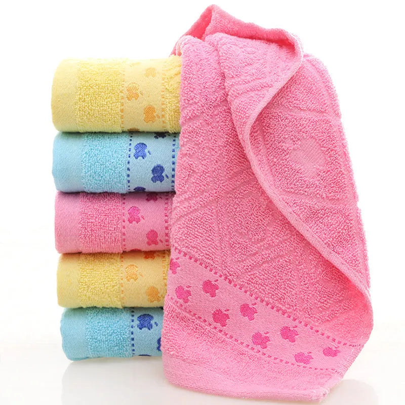 Cotton face towel in blue, pink and yellow colours with heart patterns, dimensions 73x33cm