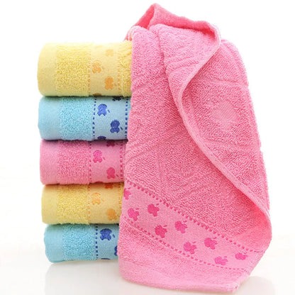 Cotton face towel in blue, pink and yellow colours with heart patterns, dimensions 73x33cm