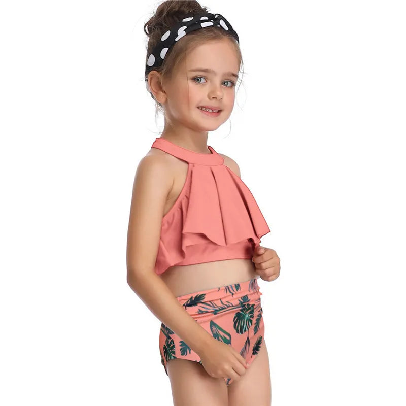 Nylon one-piece swimsuit with chest pad, available in flower, orange, and red, adult and child sizes.