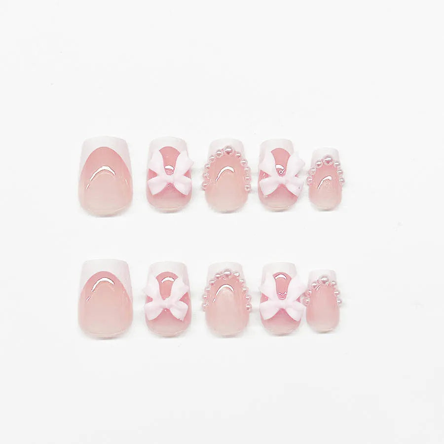 Fashion short white French cute bow manicure set with 24 nail art pieces including tulip, bow, starry sky, leopard print, and XINGX designs.