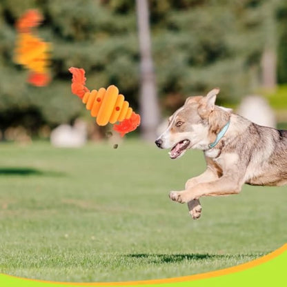 Green and yellow dog ball with attached knotted rope chew and feeder toy on grass.