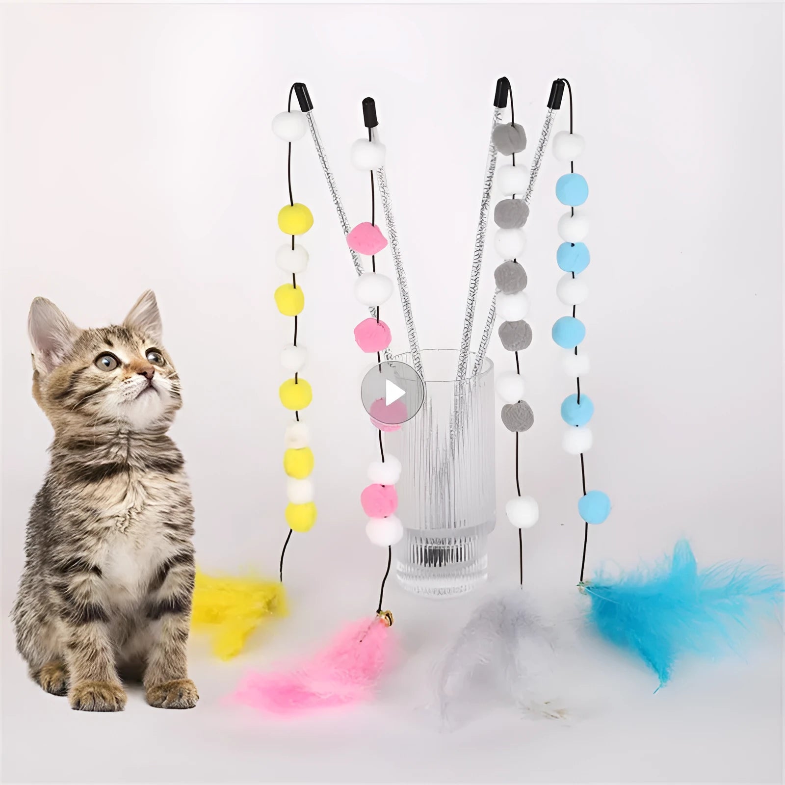 Blue cat teaser stick toy with a bell and a grey feather pompon, shown next to a grey and yellow version.