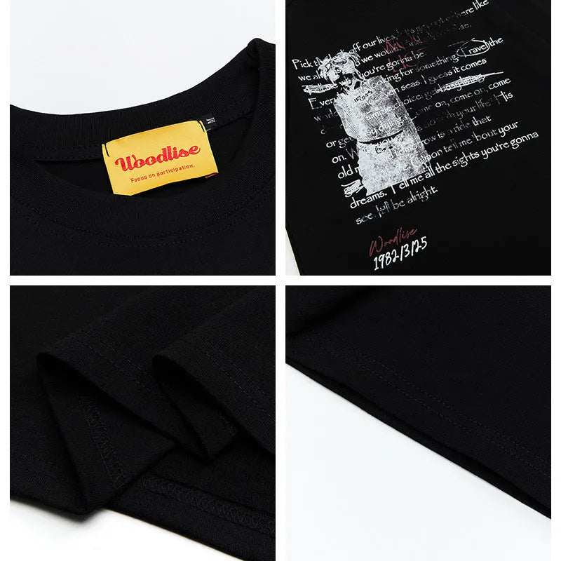 Man wearing a black loose-fit cotton t-shirt with a letter print and raglan sleeves.